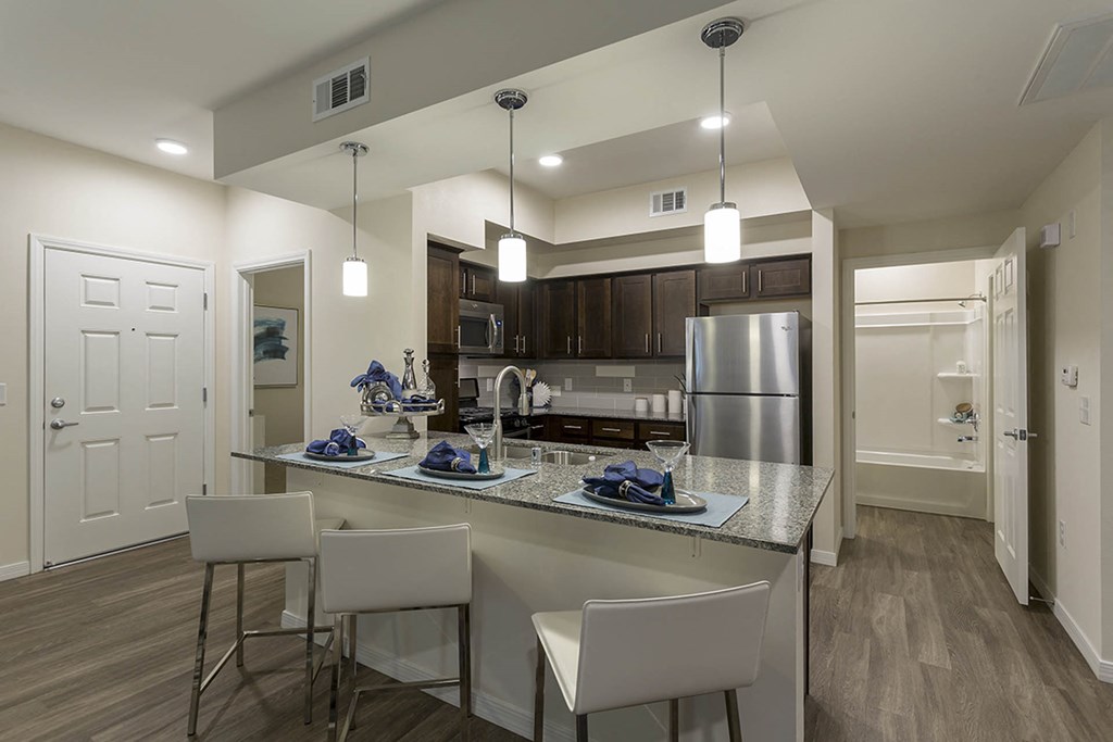 Wooden cabinets in kitchen with breakfast bar at The View at Horizon Ridge, Henderson, Nevada