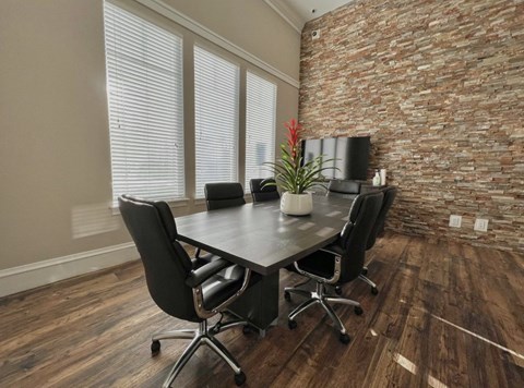 A conference room with a table and chairs.