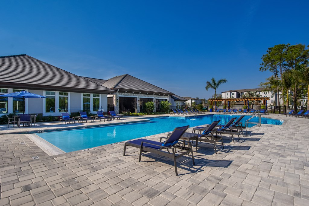 a resort style pool with lounge chairs and umbrellas  at The Oasis at Manatee River, Florida, 34211