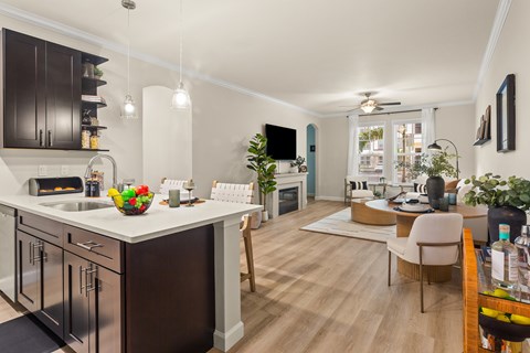 A modern kitchen with dark brown cabinets and a white countertop.
