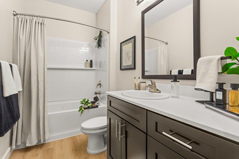 A bathroom with a white toilet, a white sink, and a white bathtub.