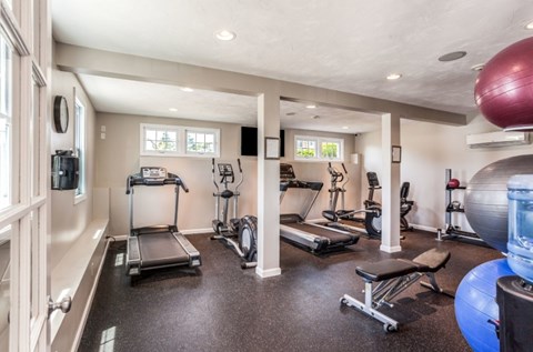 A spacious home gym with a variety of exercise equipment.