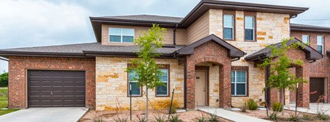 A modern house with a brick facade and a large garage door.