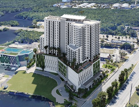 A modern multi-story building with a pool in the foreground.