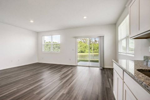 Spacious living area connected to the backyard at Beacon at Arbours in Ruskin, FL