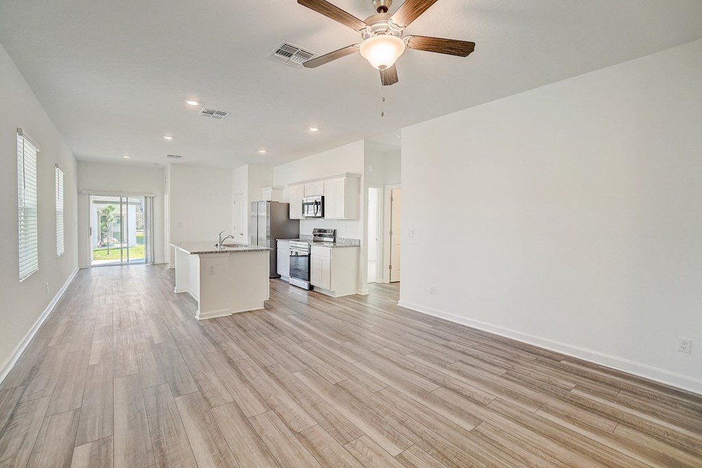 View of the kitchen from the living room in the Oak floor plan at Beacon at Clinton Corners in Dade City, FL