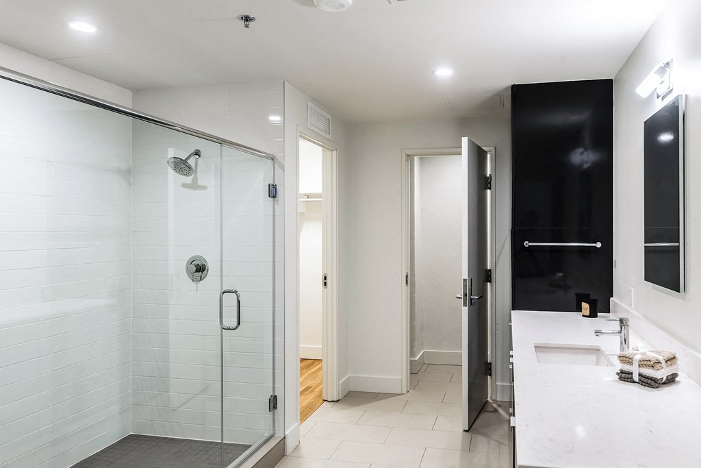 Mid Elm Lofts bathroom with walk-in shower and modern vanity in Dallas, TX
