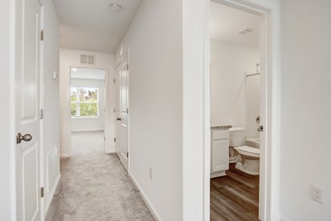 Upstairs hallway leading from master to the other two bedrooms and second full bathroom at Beacon at Arbours in Ruskin, FL