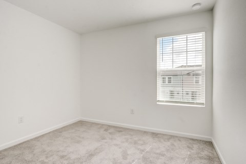 View of second bedroom with white walls and a window at Beacon at Arbours in Ruskin, FL