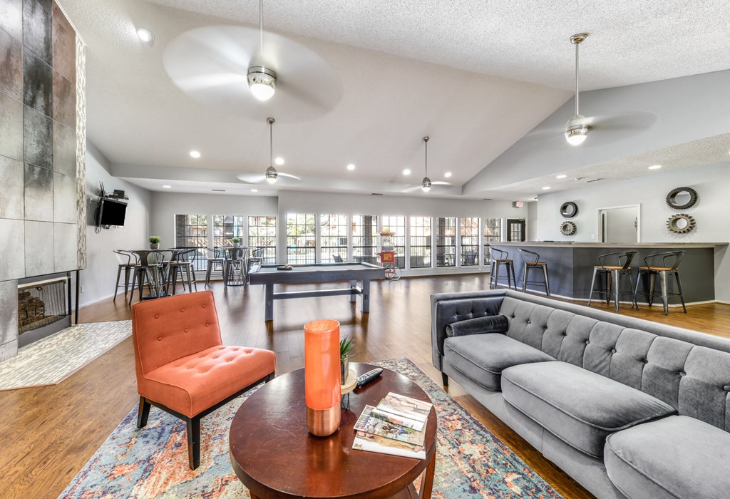 a living room with couches and a table and a fireplace