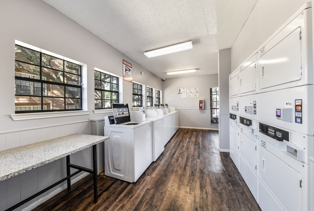 a kitchen with white appliances and a counter with a counter top and a refrigerator