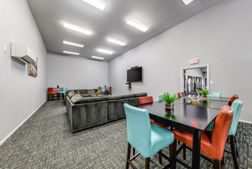a conference room with a table and chairs and a couch