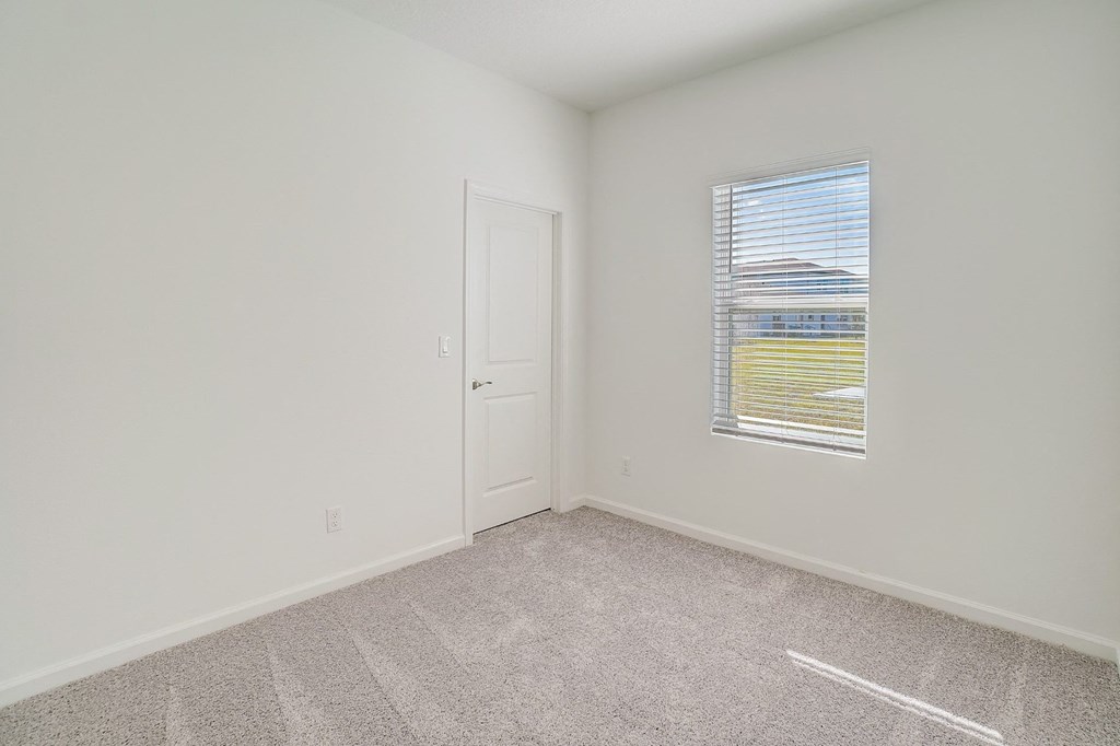 Corner view of a bedroom in the Oak floor plan at Beacon at Clinton Corners in Dade City, FL