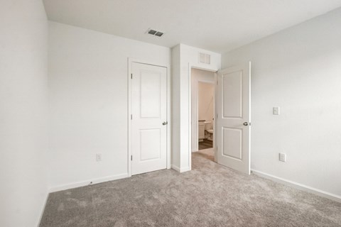 View of third bedroom with two doors and a carpeted floor area at Beacon at Arbours in Ruskin, FL