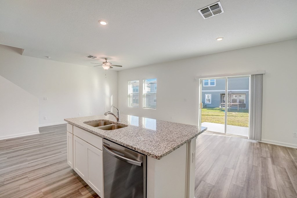 View from kitchen looking out to a sliding door leading to the backyard of the Verbena floor plan at Beacon at Clinton Corners in Dade City, FL