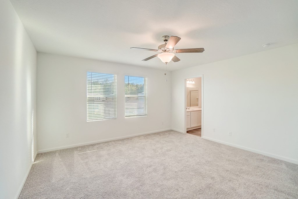 Verbena floor plan bedroom with natural lighting and ceiling fan at Beacon at Clinton Corners in Dade City, FL