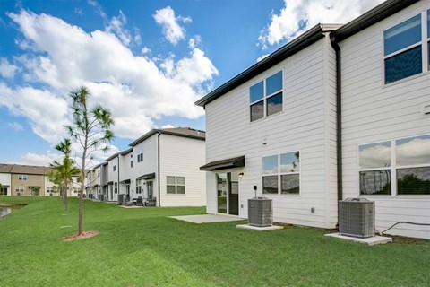 View behind the townhomes of the open yard area at Beacon at Arbours in Ruskin, FL
