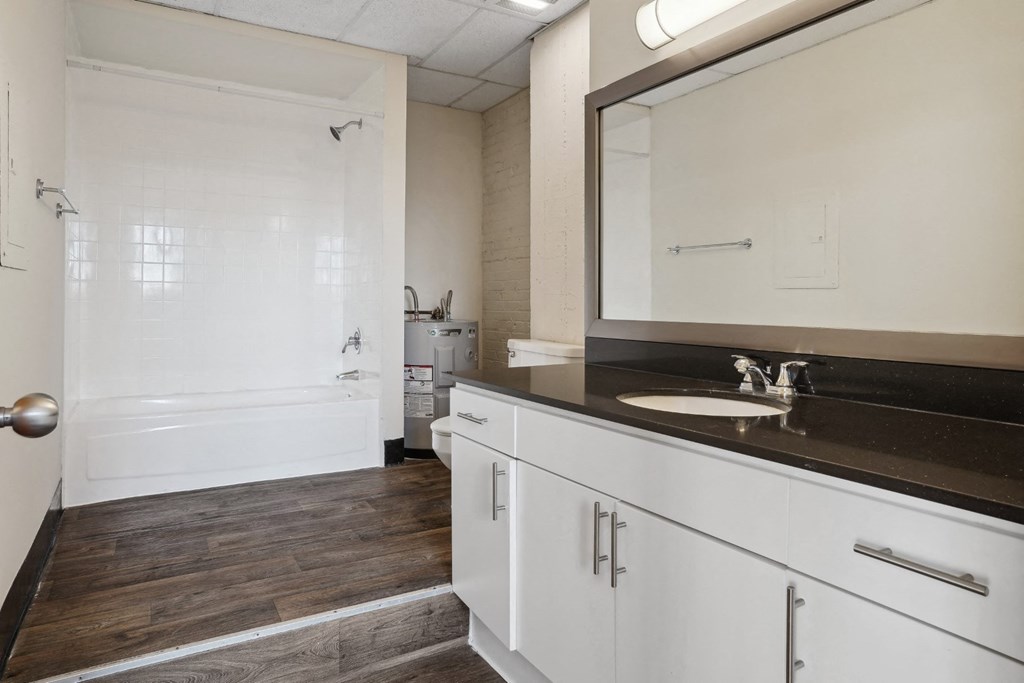 3200 Main Lofts bathroom with large vanity and step up to shower | Deep Ellum Lofts in Dallas, TX
