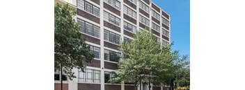 a large building with trees in front of it