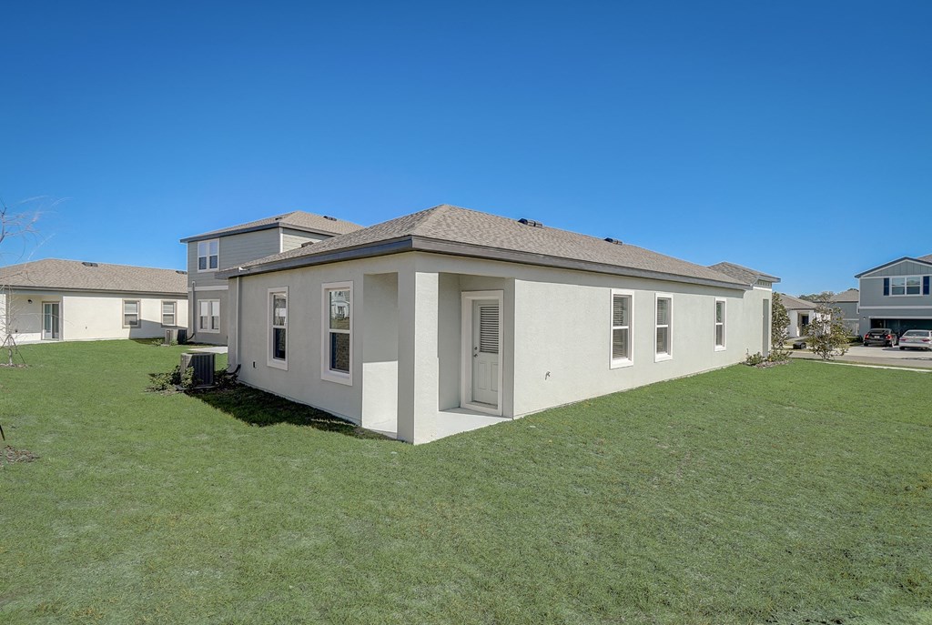 Side view of Elm floor plan house from the backyard at Beacon at Clinton Corners in Dade City, FL