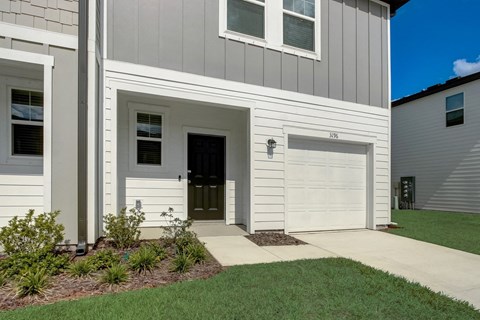 Exterior of single family rental house with garage and driveway at Beacon at Arbours in Ruskin, FL