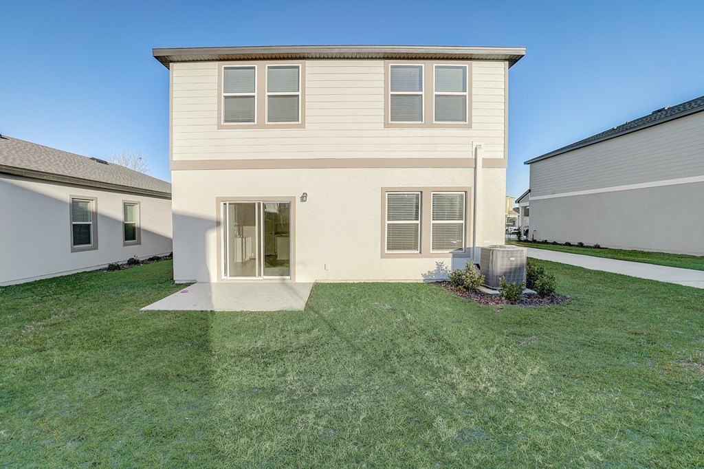 Backyard with lush green grass of the Maple floor plan at Beacon at Clinton Corners in Dade City, FL