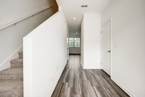 Entry overlooking staircase and hallway to living room and kitchen area at Beacon at Arbours in Ruskin, FL