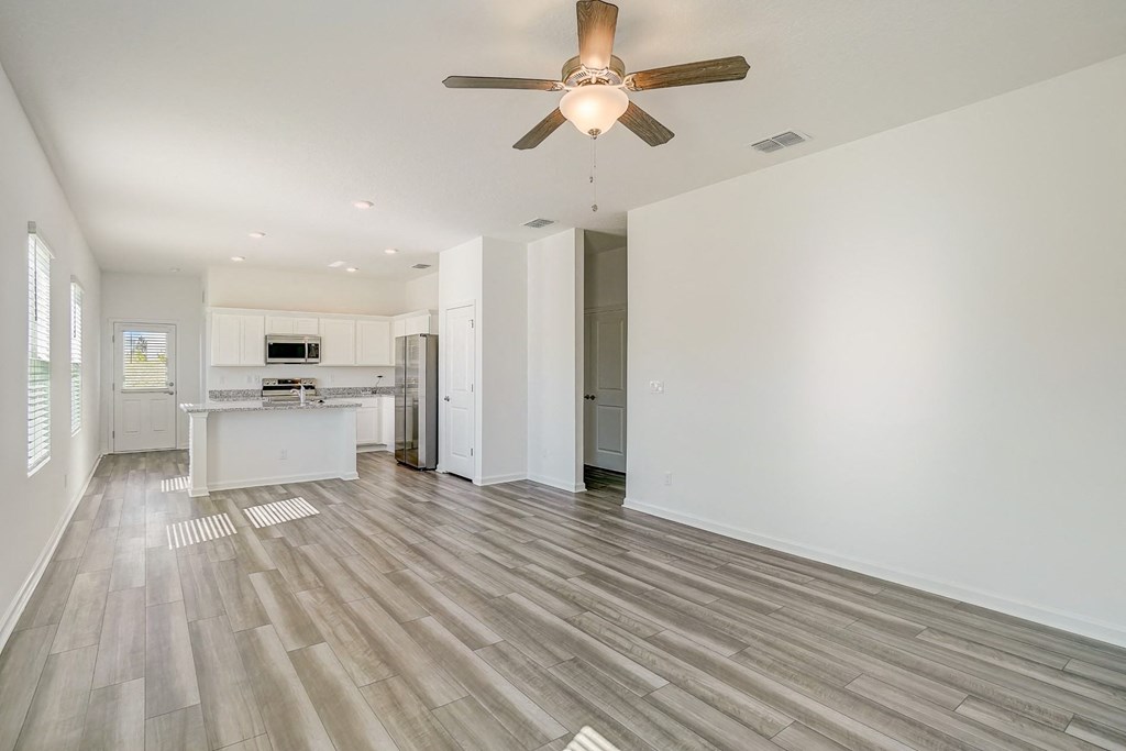 View from living room to kitchen in the Elm floor plan at Beacon at Clinton Corners in Dade City, FL