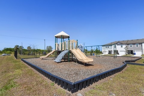 a playground with a slide and climbing structure at Beacon at Arbours, Ruskin, 33570