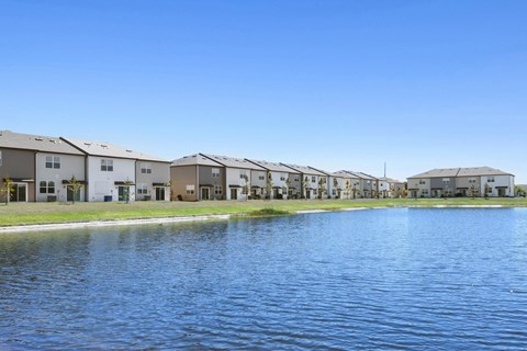a large body of water in front of a row of houses at Beacon at Arbours, Florida
