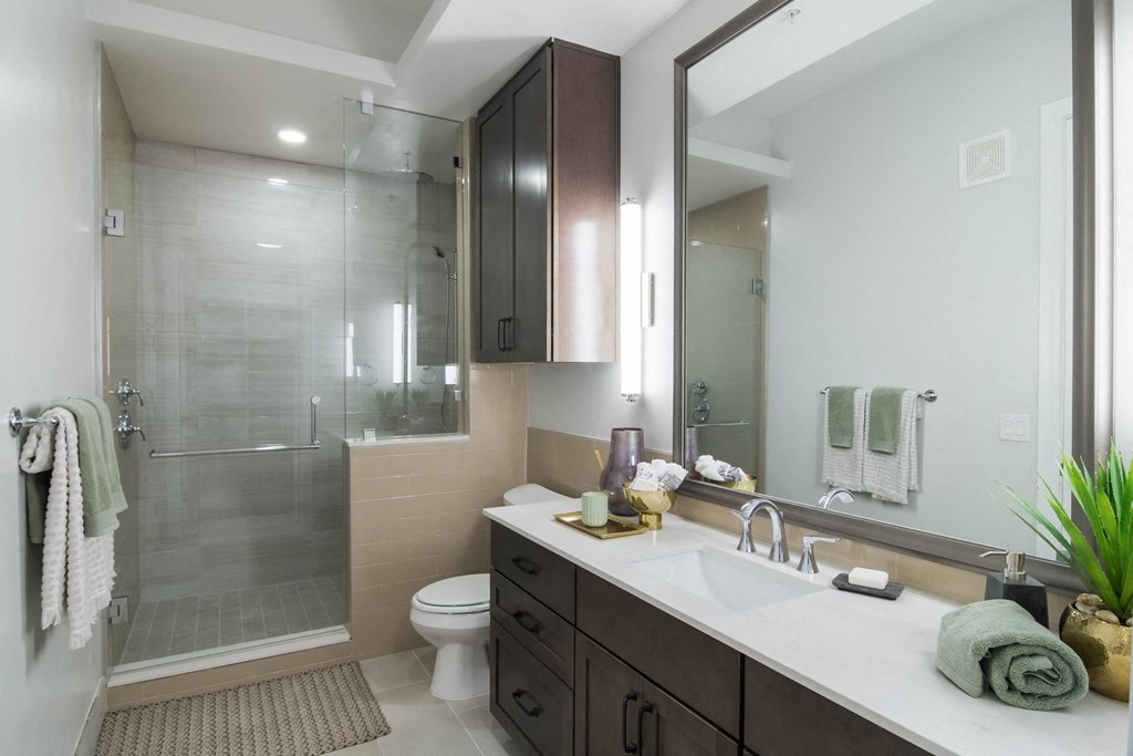 Walk-In Showers With Built-In Bench And Glass Enclosure at The Alastair at Aria Village, Sandy Springs, Georgia