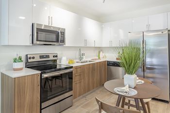Sleek, modern kitchens with white quartz countertops at Alameda West, Miami