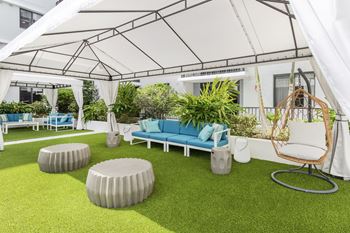 Tropical pool deck with large sundeck and cabanas at Alameda West, Miami, FL