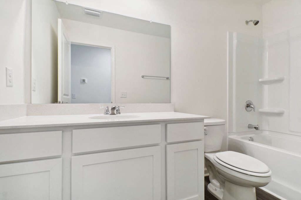 Bright bathroom featuring a spacious countertop and a combined shower and tub at Beacon at Ashley River Landing in Summerville, SC