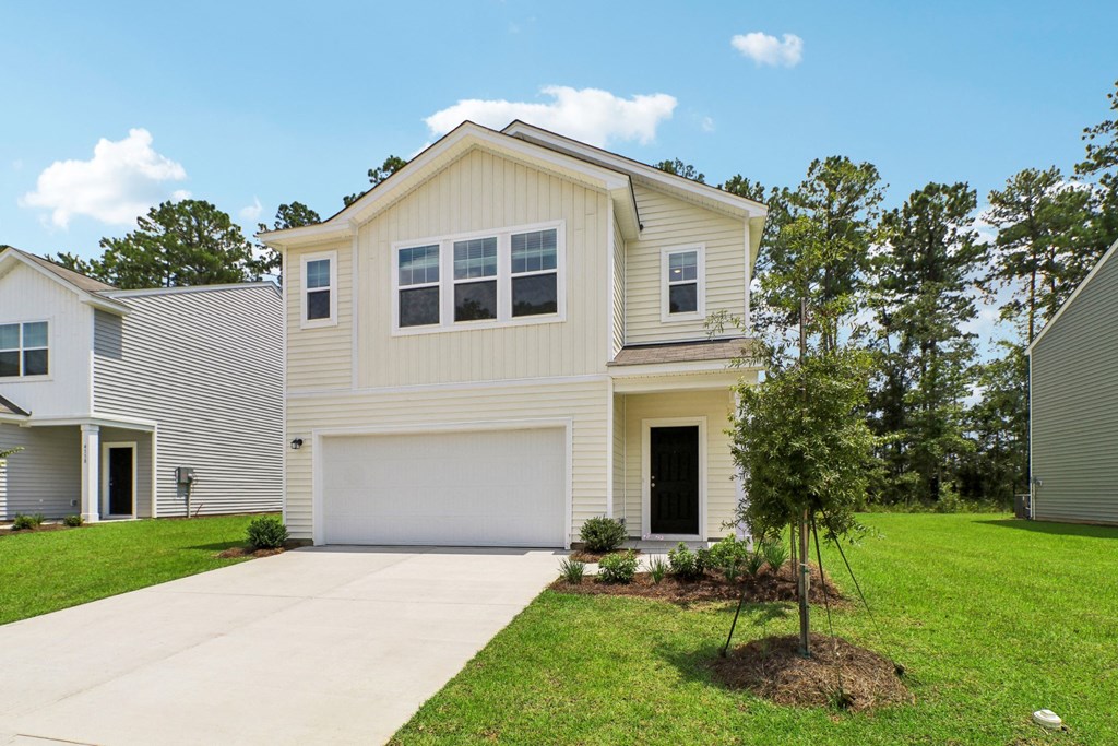 Front view of the apartment, highlighting the main entrance and surrounding greenery at Beacon at Ashley River Landing in Summerville, SC