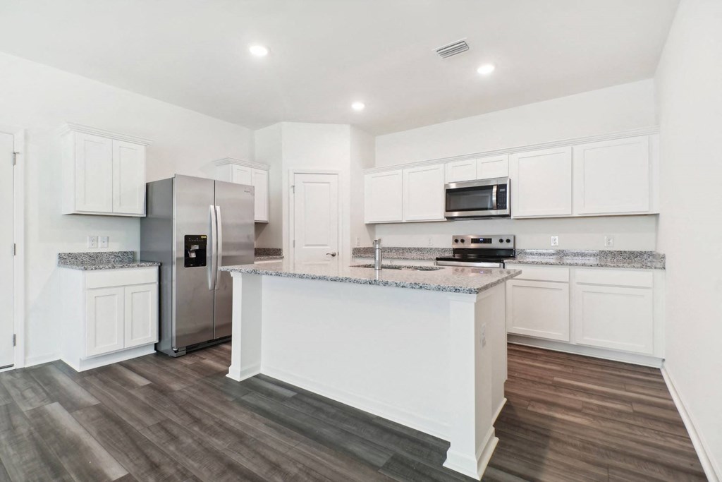 Spacious kitchen with island and granite countertops at Beacon at Ashley River Landing in Summerville, SC