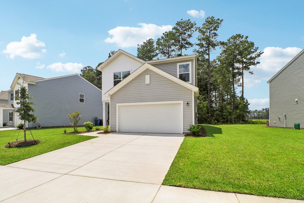 Side view of a two-story house with a white and gray exterior at Beacon at Ashley River Landing in Summerville, SC
