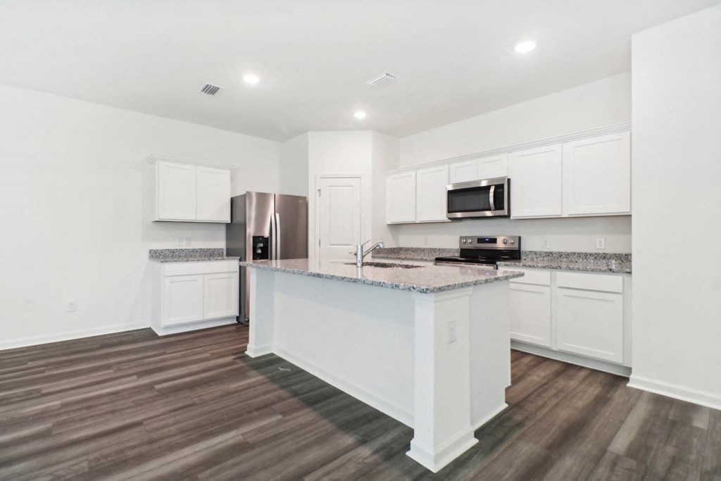 Maple kitchen with an island and a stainless steel at Beacon at Ashley River Landing in Summerville, SC