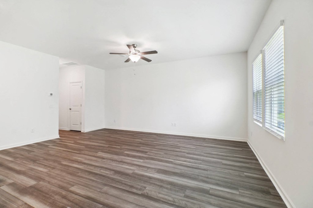Maple living room with a ceiling fan and wood floor at Beacon at Ashley River Landing in Summerville, SC