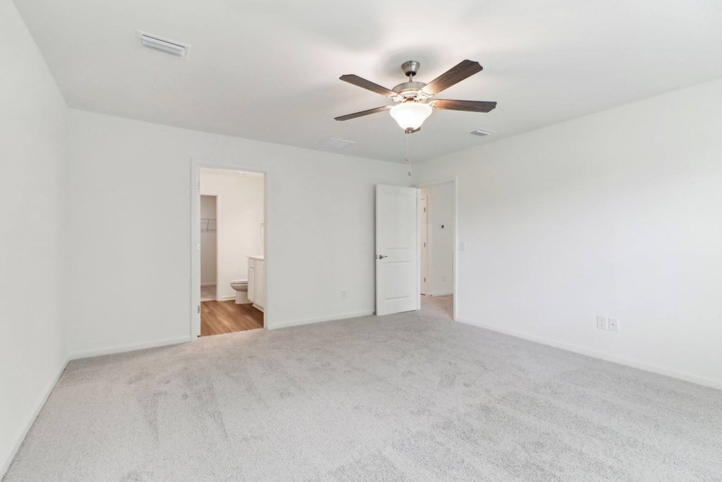 Maple bedroom with white walls and a ceiling fan at Beacon at Ashley River Landing in Summerville, SC