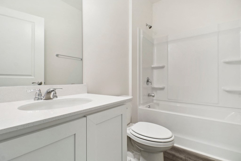 Oak white bathroom with a sink toilet and shower at Beacon at Ashley River Landing in Summerville, SC