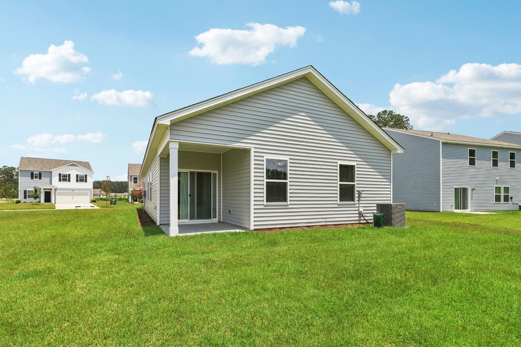 Side view of a single-story home with a covered patio at Beacon at Ashley River Landing in Summerville, SC