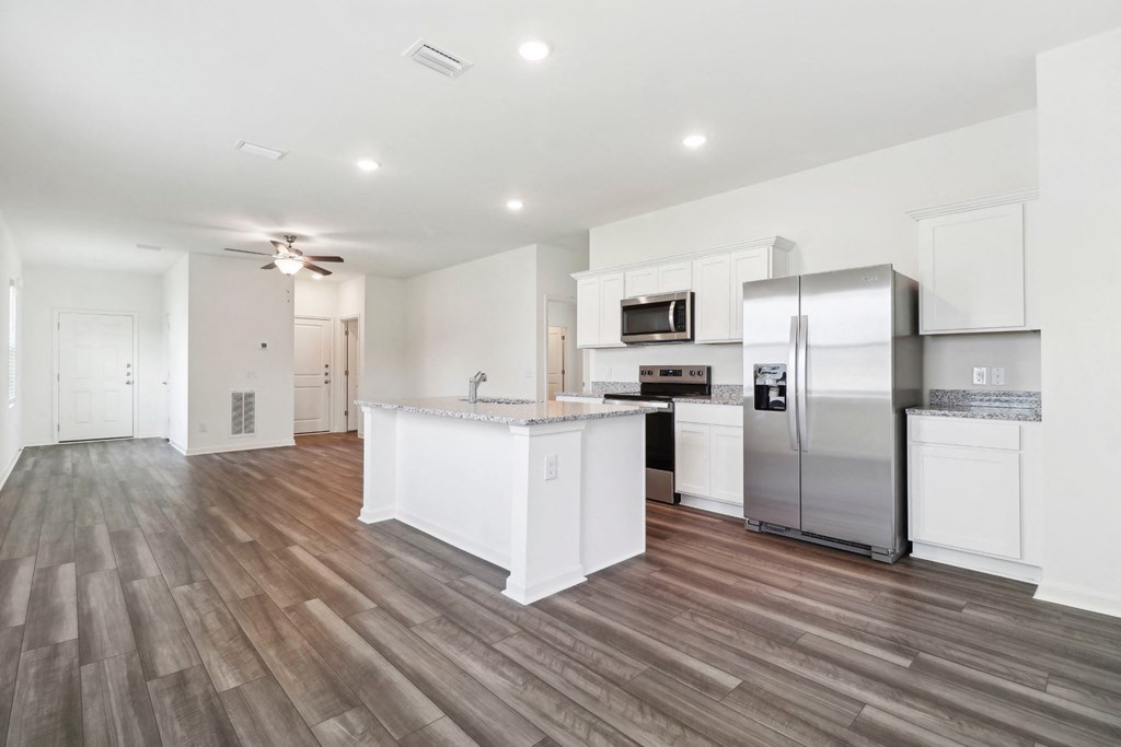 Oak open kitchen with a large island and stainless steel appliances at Beacon at Ashley River Landing in Summerville, SC