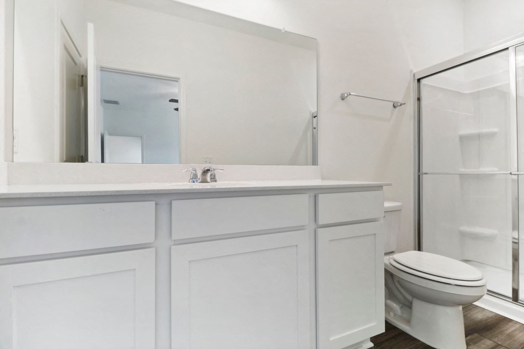 Oak master bathroom with a glass-enclosed shower at Beacon at Ashley River Landing in Summerville, SC