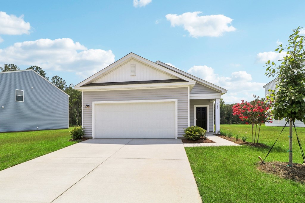 Exterior view of a single-story home with a two-car garage at Beacon at Ashley River Landing in Summerville, SC