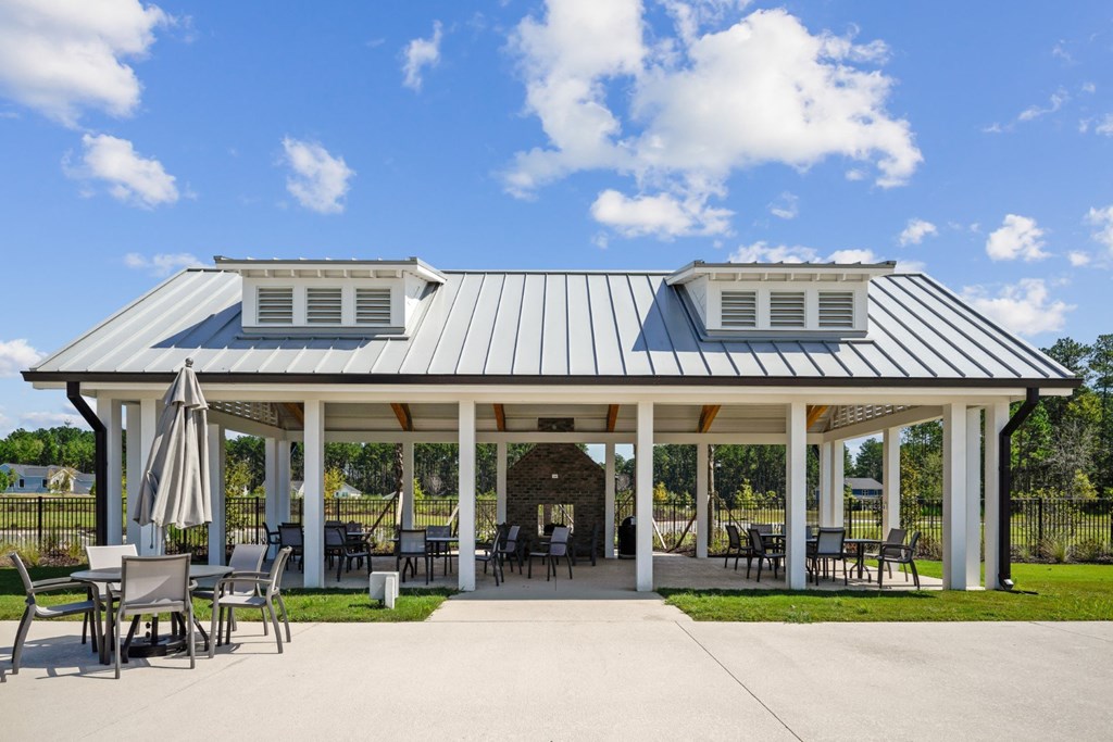 Pavilion next to pool and playground under a blue sky at at Beacon at Ashley River Landing in Summerville, SC