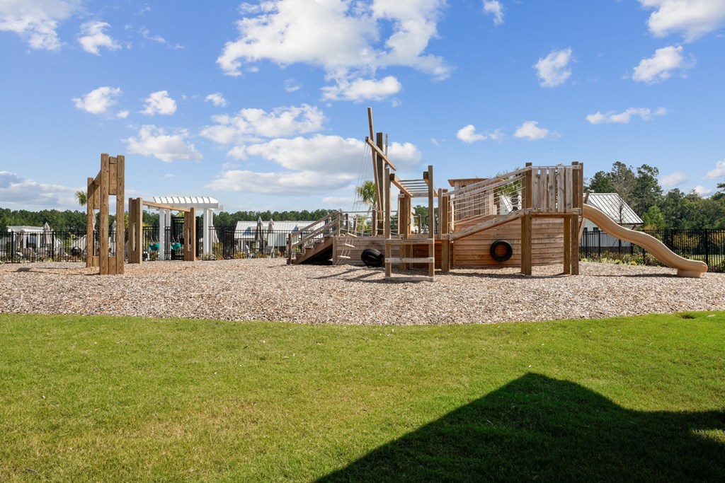 Playground in the shape of a boat with swing set and slide at Beacon at Ashley River Landing in Summerville, SC