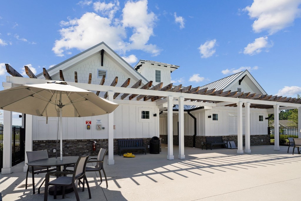 Poolside seating with umbrellas for shade at at Beacon at Ashley River Landing in Summerville, SC