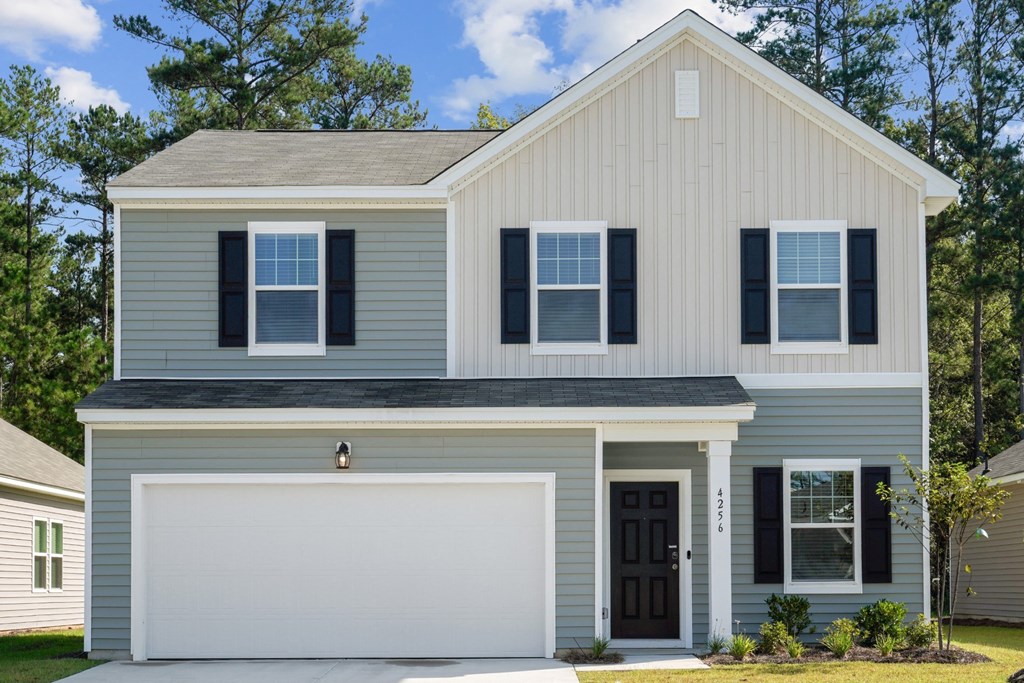 Front view of the Redbud floor plan house painted in a blue and off-white color scheme at Beacon at Ashley River Landing in Summerville, SC