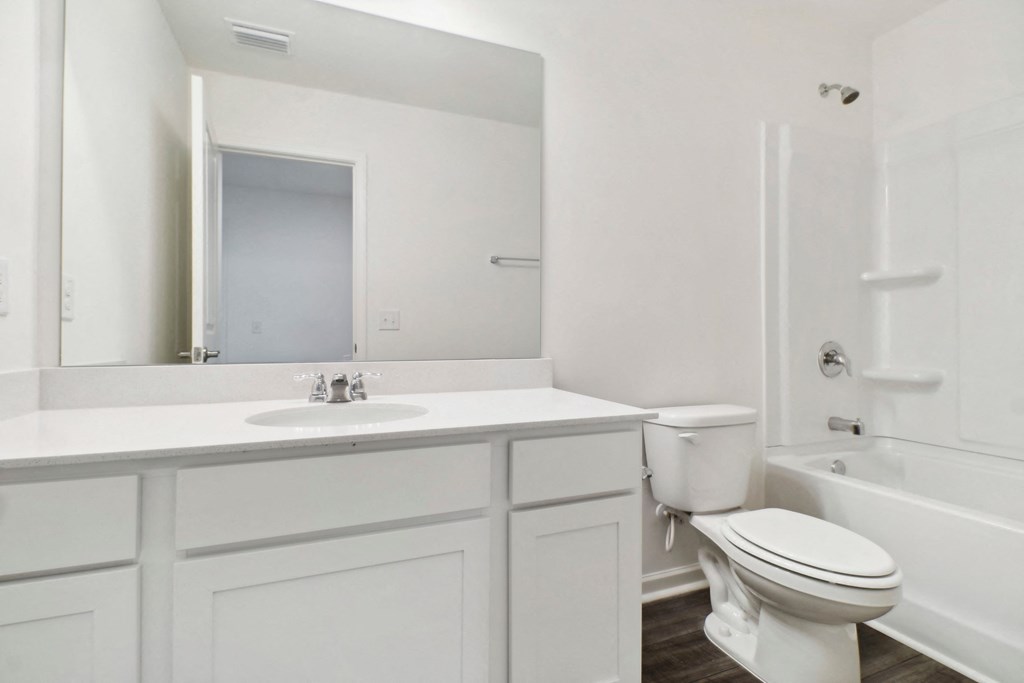a bathroom with a sink toilet and a mirror